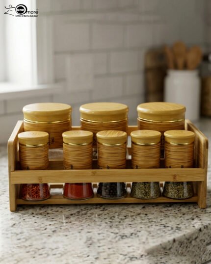 A high-angle view of a glass spice jar and salt shaker set held within a natural bamboo wooden stand, displayed on a rustic wooden table with fresh herbs.