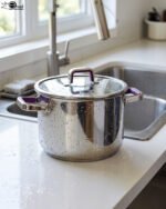 A 2-in-1 non-stick stainless steel cooker set in 6L and 8L sizes, made in Turkey, displayed on a kitchen counter, available at OneMore.