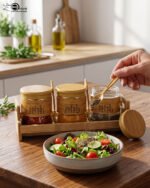 A set of three glass jars with bamboo lids and labels, neatly arranged on a wooden stand in a modern kitchen setting, as seen in 1.jpg.