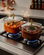 Three premium square glass cooking pots in 3.5L, 4L, and 5L sizes with ornate gold lid knobs on a marble kitchen countertop.