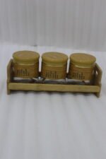 A set of three glass jars with bamboo lids and labels, neatly arranged on a wooden stand in a modern kitchen setting, as seen in 1.jpg.