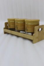 A set of three glass jars with bamboo lids and labels, neatly arranged on a wooden stand in a modern kitchen setting, as seen in 1.jpg.