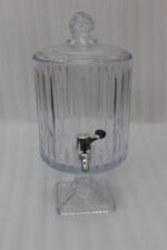 Elegant 4.5L glass beverage dispenser filled with iced lemonade and mint, resting on a pedestal stand on a wooden kitchen counter.