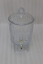 Elegant 4.5L glass beverage dispenser filled with iced lemonade and mint, resting on a pedestal stand on a wooden kitchen counter.