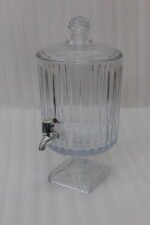 Elegant 4.5L glass beverage dispenser filled with iced lemonade and mint, resting on a pedestal stand on a wooden kitchen counter.
