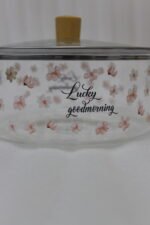 Alt Text: One More 2.5L square glass pot with floral prints, clear glass lid, and a wooden knob resting on a marble countertop.