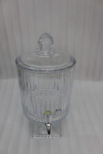 Elegant 4.5 Liter ribbed glass beverage dispenser with a silver spigot and decorative stand, filled with water, lemon slices, blueberries, and mint leaves on an outdoor wooden table, as shown in 2.jpg.