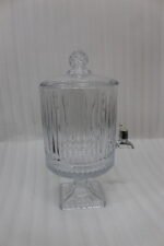 Elegant 4.5 Liter ribbed glass beverage dispenser with a silver spigot and decorative stand, filled with water, lemon slices, blueberries, and mint leaves on an outdoor wooden table, as shown in 2.jpg.