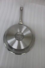 A set of four Made-in-Turkey stainless steel non-stick fry pans in sizes 20cm, 22cm, 24cm, and 26cm arranged on a kitchen counter.