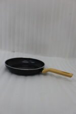 A collection of Turkish-made diamond-infused non-stick frying pans in various sizes ranging from 20cm to 30cm, displayed on a kitchen wall and countertop at OneMore.