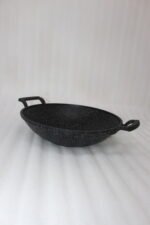 A 30cm granite-coated non-stick open wok being cleaned on a countertop, showcasing its durable surface.