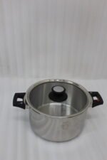 Falez 6L non-stick stainless steel 6-piece cooker set featuring a pot, lid, two spoons, and a heat-resistant table pad on a countertop.