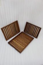 A high-quality 3-piece wooden tray set stacked on a modern kitchen countertop, featuring a natural wood grain finish and durable design, available at OneMore.