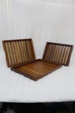 A high-quality 3-piece wooden tray set stacked on a modern kitchen countertop, featuring a natural wood grain finish and durable design, available at OneMore.