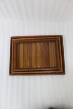 A high-quality 3-piece wooden tray set stacked on a modern kitchen countertop, featuring a natural wood grain finish and durable design, available at OneMore.