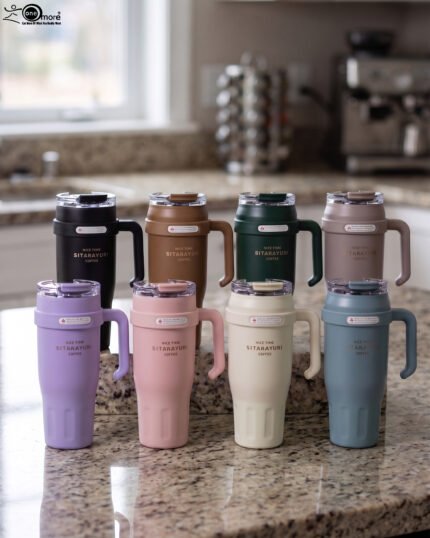 : An array of colorful 1.2L stainless steel tumblers with handles and clear lids displayed on a kitchen counter