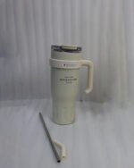 : An array of colorful 1.2L stainless steel tumblers with handles and clear lids displayed on a kitchen counter