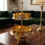 Luxury 2-tier gold decorative serving tray with silver floral accents on a wooden table