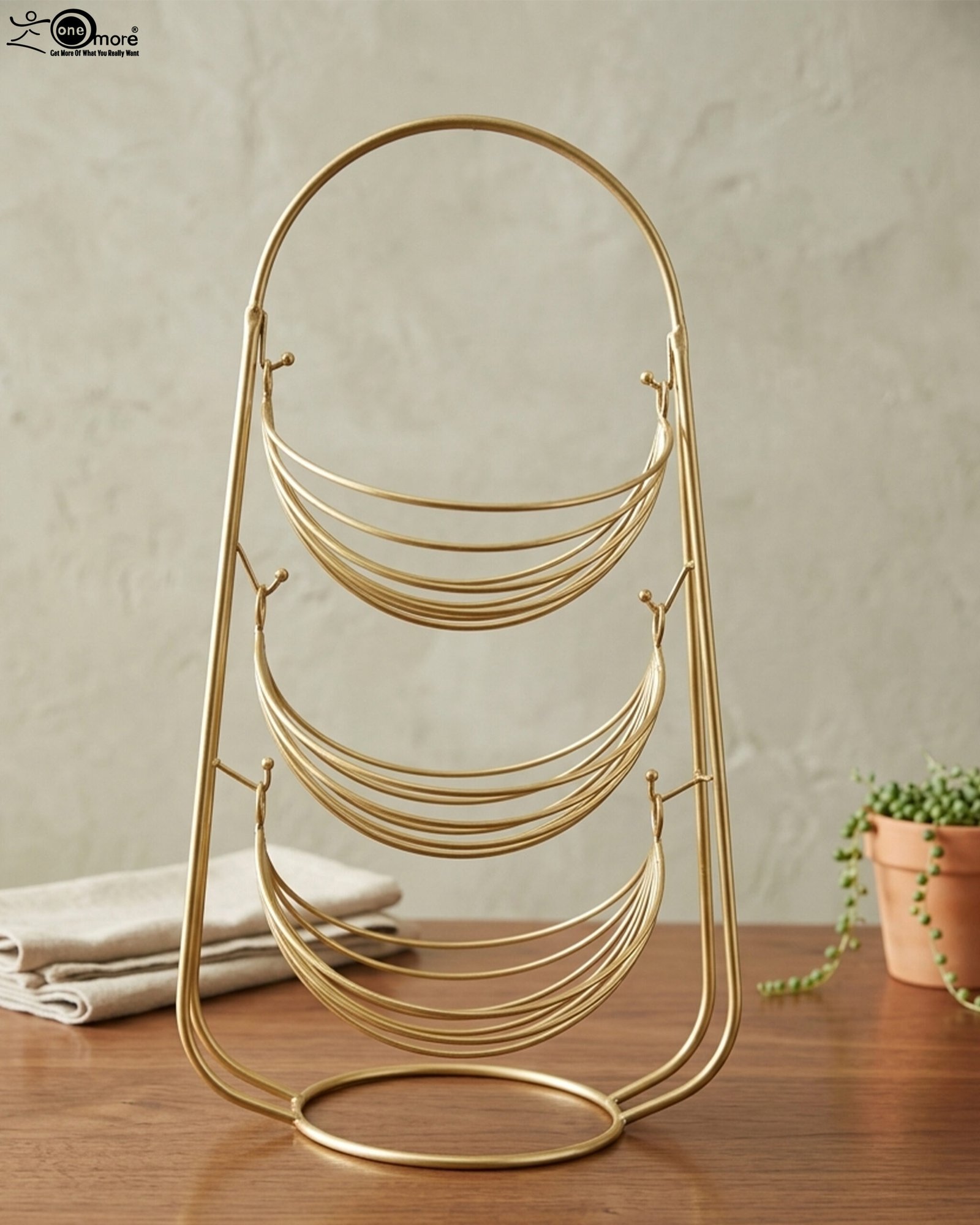 1 3-tier gold wire decorative metal baskets stand on a wooden table