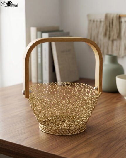 Gold woven wire decorative basket with a natural wooden handle sitting on a wooden tabletop