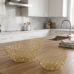 Set of two gold wire decorative metal baskets sitting on a wooden kitchen island counter