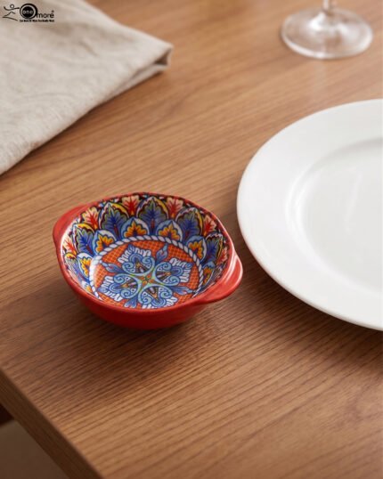 4-inch hand-painted decorative Marrakech ceramic piyali bowl with vibrant blue, yellow, and red pattern resting on a wooden table.
