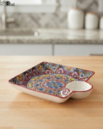 Square ceramic Marrakech serving platter with intricate colorful mosaic patterns and an attached side dip bowl on a wooden countertop.