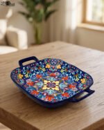 Square ceramic 6-inch Marrakesh decorative bowl with vibrant floral mandala pattern and side handles sitting on a wooden table.