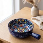 6-inch vibrant blue decorative Marrakesh ceramic bowl with colorful mosaic patterns and side handle on a wooden table.