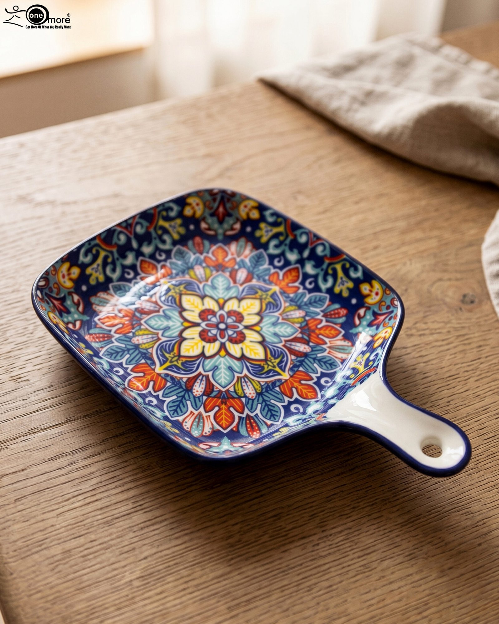1 Square 6.5-inch Marrakech ceramic serving dish with colorful mosaic mandala patterns and an integrated handle on a wooden table.