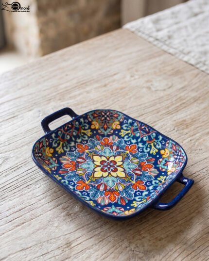 Vibrant blue 9.5-inch decorative Marrakech ceramic serving bowl with handles featuring a colorful mandala pattern on a rustic wooden table.