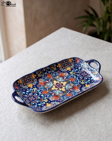 Intricate vibrant blue and yellow Marrakech ceramic serving dish tray with built-in handles on a stone countertop