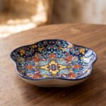 Decorative Marrakesh serving dish with a colorful ceramic mandala pattern and wavy edges on a wooden table