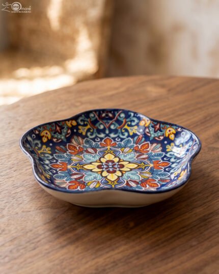 Decorative Marrakesh serving dish with a colorful ceramic mandala pattern and wavy edges on a wooden table
