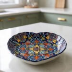 Decorative Marrakesh ceramic serving dish with colorful bohemian mandala pattern resting on a white marble kitchen countertop