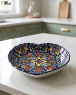 Decorative Marrakesh ceramic serving dish with colorful bohemian mandala pattern resting on a white marble kitchen countertop