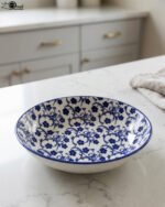 8-inch ceramic decorative Marakesh bowl with intricate blue and white floral pattern resting on a white countertop