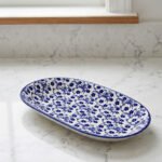 11-inch oval ceramic decorative Marrakesh serving dish with blue and white floral patterns on a light marble countertop.