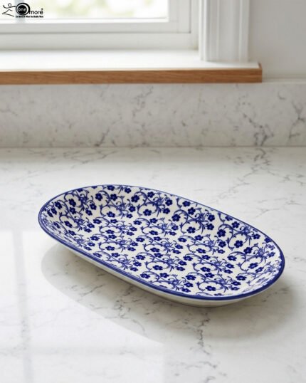 11-inch oval ceramic decorative Marrakesh serving dish with blue and white floral patterns on a light marble countertop.