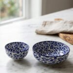 Pair of blue and white handcrafted decorative Marrakesh ceramic bowls in 5-inch and 8-inch sizes on a marble countertop