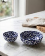 Pair of blue and white handcrafted decorative Marrakesh ceramic bowls in 5-inch and 8-inch sizes on a marble countertop