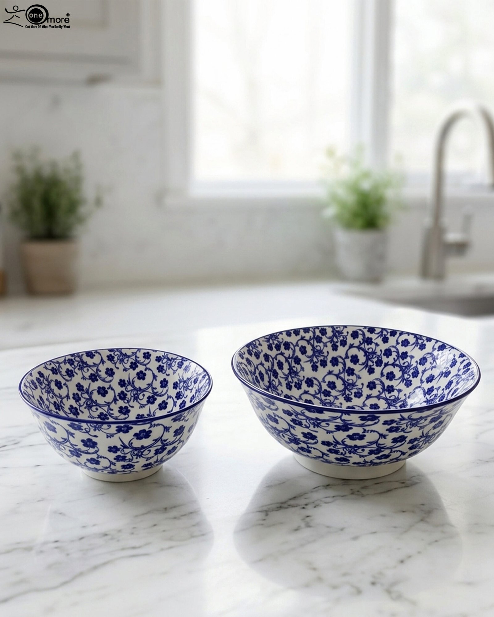 1 Pair of decorative blue and white Marrakesh ceramic floral bowls in 6-inch and 8-inch sizes sitting on a marble kitchen countertop.