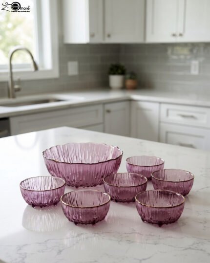 7-piece grey ribbed glass fruit set featuring one large serving bowl and six small bowls with elegant gold rims, displayed on a kitchen counter.