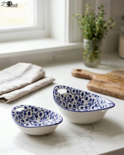 Two decorative Marakesh blue and white floral ceramic serving dishes with handles resting on a kitchen countertop.