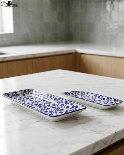 Two rectangular blue and white decorative Marrakesh serving dishes in 8-inch and 10-inch sizes displayed on a marble countertop.