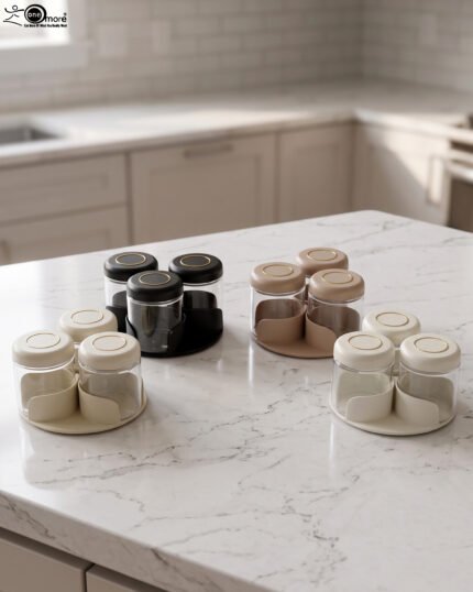 Four modern glass spice jar sets in black, tan, cream, and off-white with gold lid rings arranged on a marble kitchen countertop.