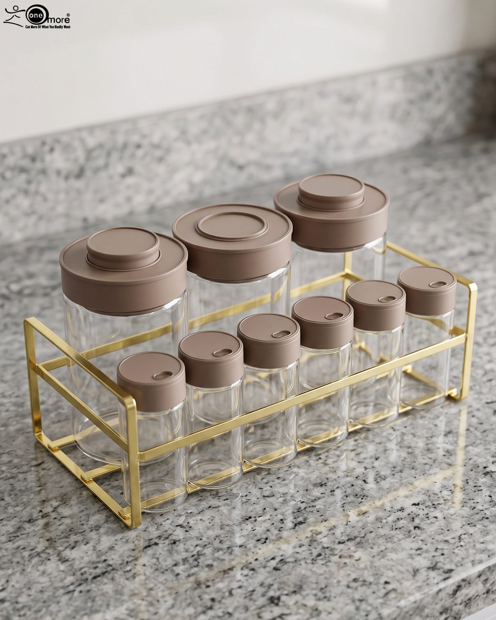 1 A 9-piece glass spice jar set with matte brown lids and gold-tone metal rack sitting on a granite countertop.