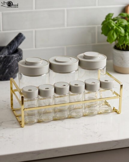 9-piece clear glass spice jar set with grey lids and a gold wire countertop rack