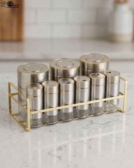 9-piece brushed stainless steel and glass spice jar set with gold rim accents arranged on a gold metal countertop rack