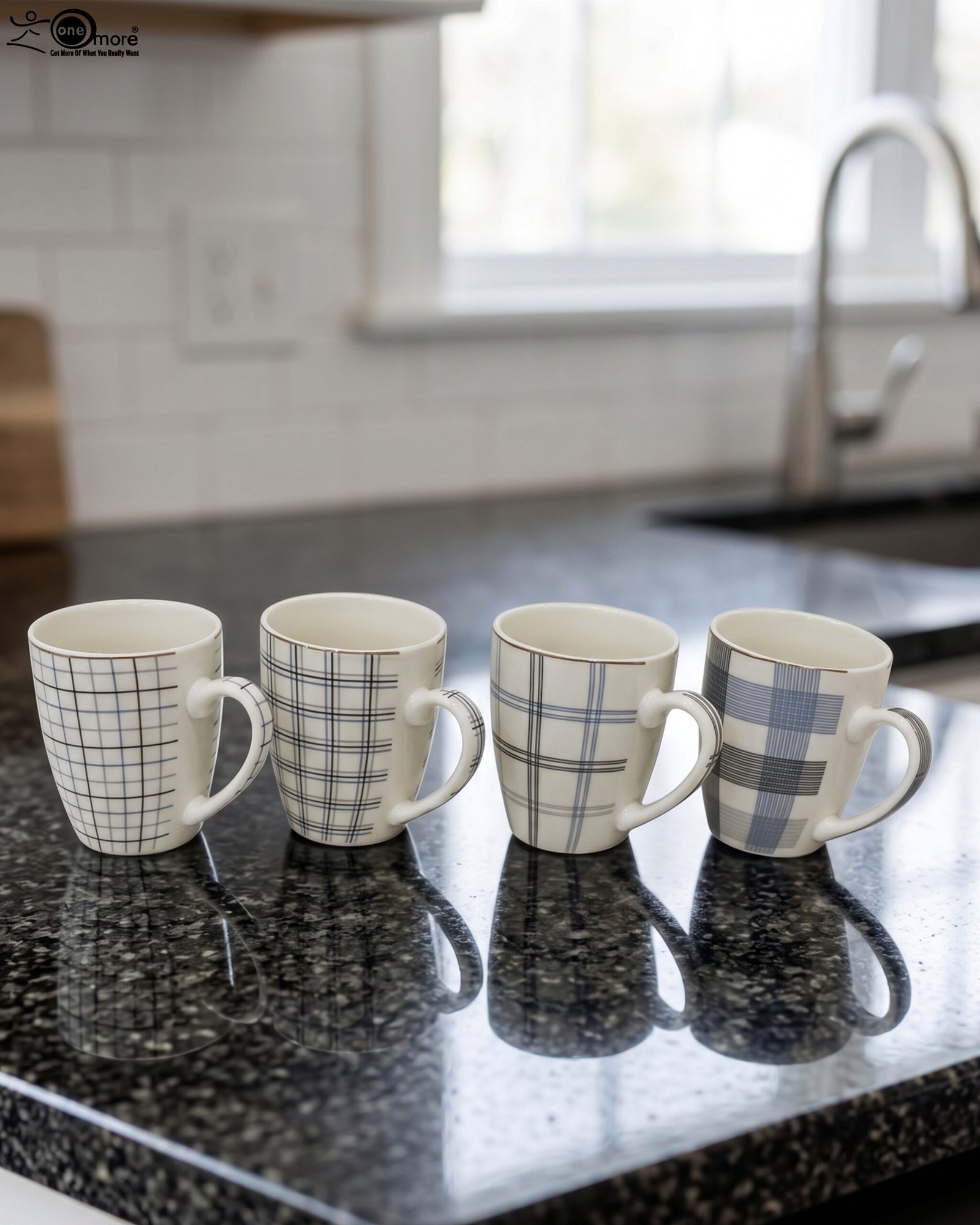 1 Set of 4 ceramic coffee mugs with blue and grey plaid grid patterns displayed on a kitchen countertop.